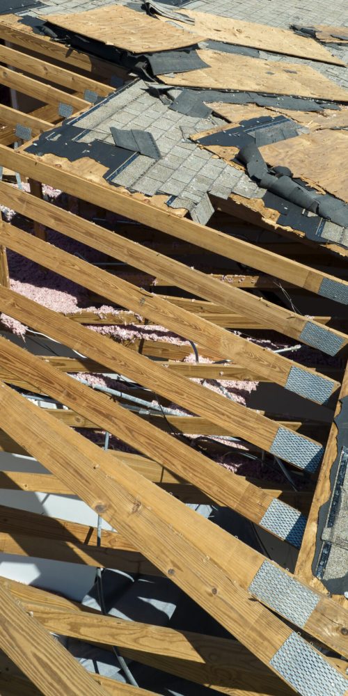 Hurricane Ian destroyed house roof in Florida residential area. Natural disaster and its consequences.