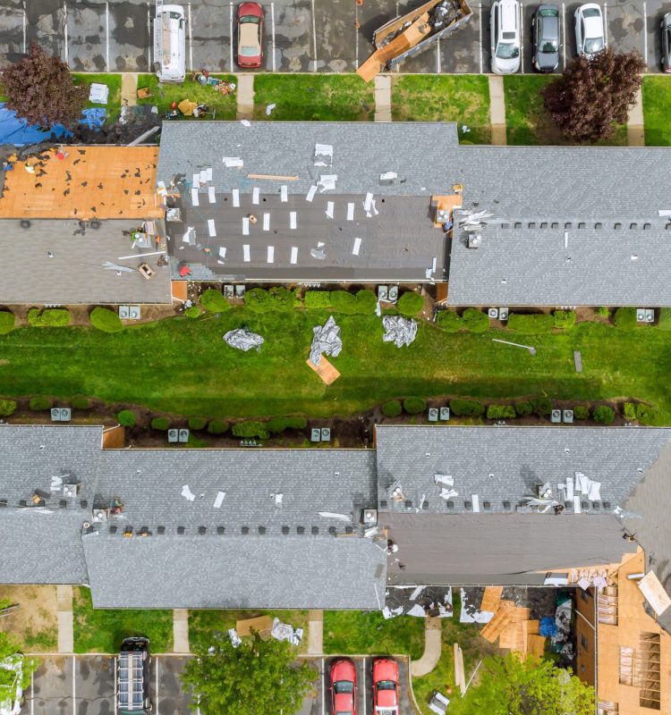 Roof repairs old roof replacement with new shingles of an apartment building